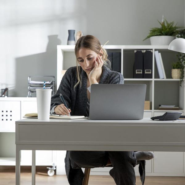 medium-shot-woman-working-desk